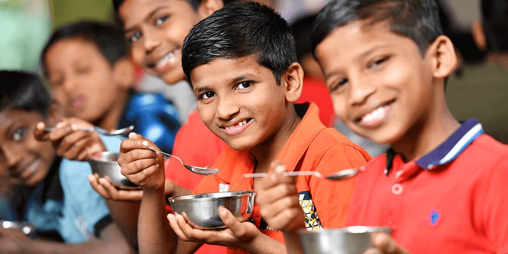 Kids enjoying Kellogg's breakfast bowl as part of make a difference program
