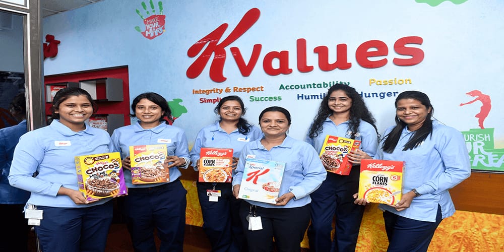 Lady employees holding and showcasing Kellogg's product line