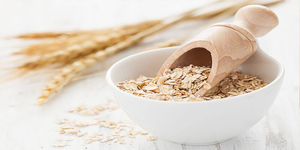 Bowl of Oats with Wooden Scoop